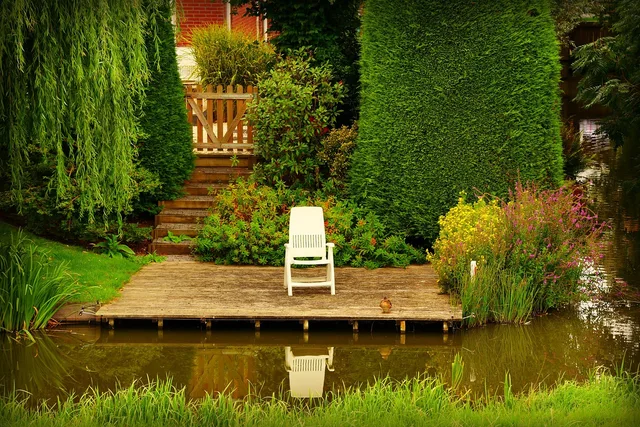 wooden patio, chair, furniture, nature, garden, water, pond, tree, reflection. A patio furniture checklist for measuring, access, storm stowing and upkeep