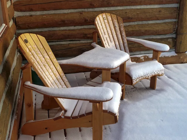 wooden, garden chairs, snow covered, log home, wood, winter, cold, brown snow. How the National Building Code of Canada shapes covered patio design