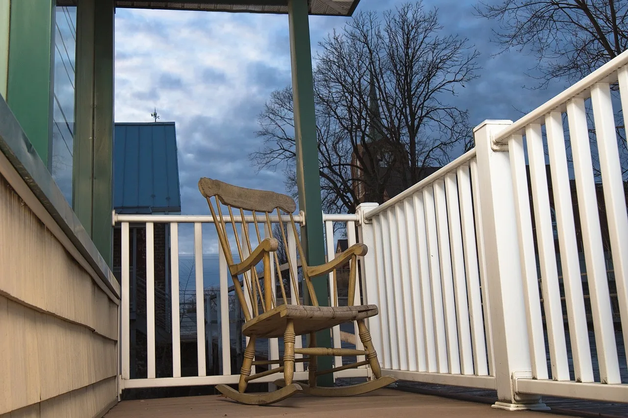 peaceful, rocking chair, porch, relaxation, leisure, tranquil, outdoors, inviting, restful, calm, chair, rocking chair, rocking chair, rocking chair, rocking chair, rocking chair. Porch restoration materials compared: softwood versus composite versus vinyl