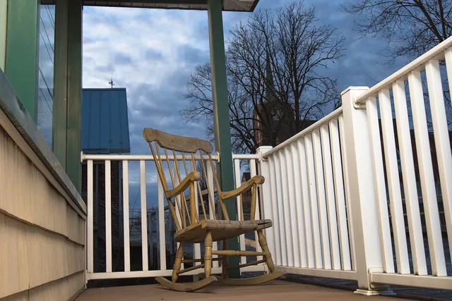 peaceful, rocking chair, porch, relaxation, leisure, tranquil, outdoors, inviting, restful, calm, chair, rocking chair, rocking chair, rocking chair, rocking chair, rocking chair. Porch restoration materials compared: softwood versus composite versus vinyl