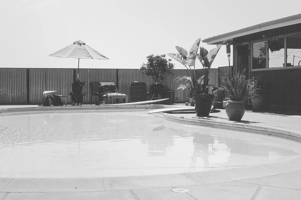 pool, backyard, umbrella, nature, patio, plants, house, gray house, gray umbrella. Shade beats an outdoor kitchen for everyday value, hour for hour